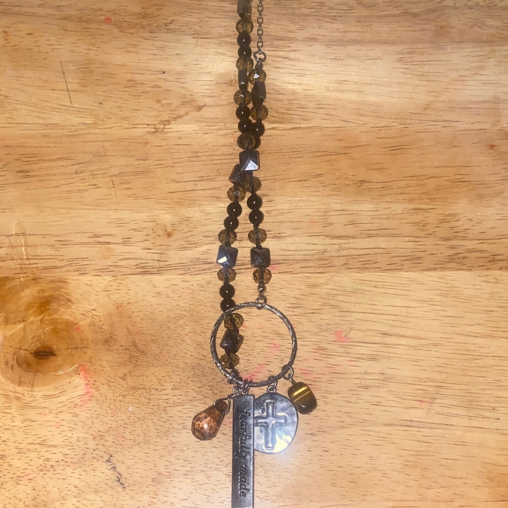 Long brown beaded necklace with Christian charms